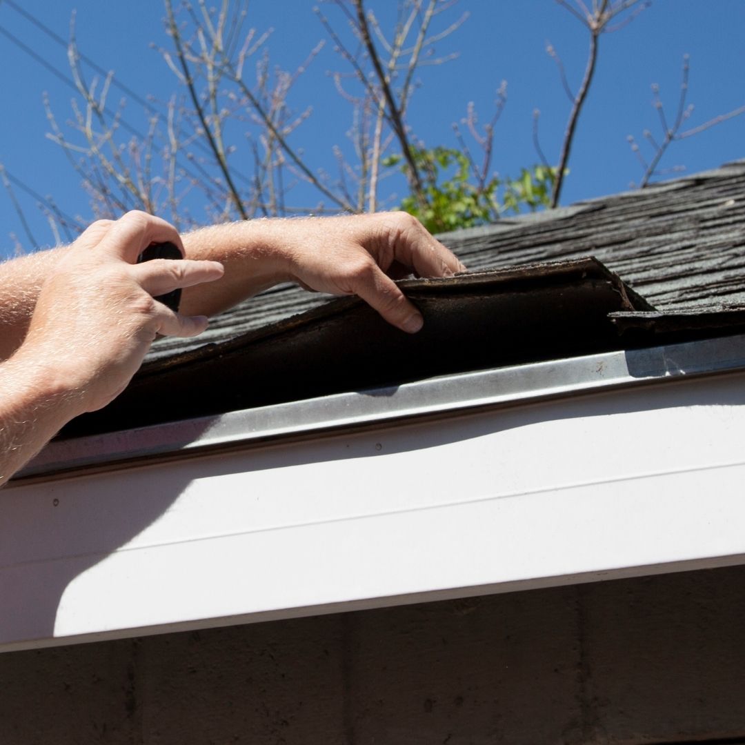 inspector takes photos of roof shingles