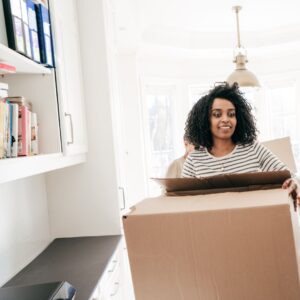woman putting items in a box