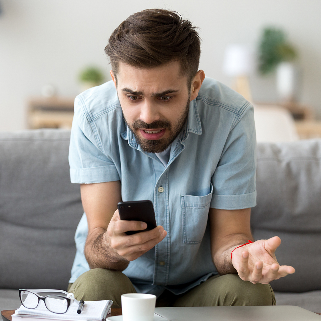 man confused looking at his phone