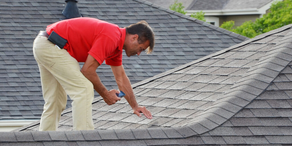 man inspecting a roof